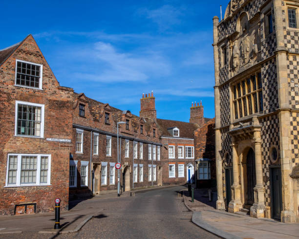 Queen Street in Norfolk, UK A view of the beautiful Georgian architecture of Queen Street in the market town of Kings Lynn in Norfolk, UK. The facade of Kings Lynn Town Hall is on the right-handside. kings lynn stock pictures, royalty-free photos & images