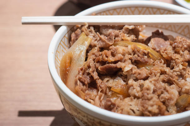 istock Rice topped with slice beef, Japanese food. 1406919190