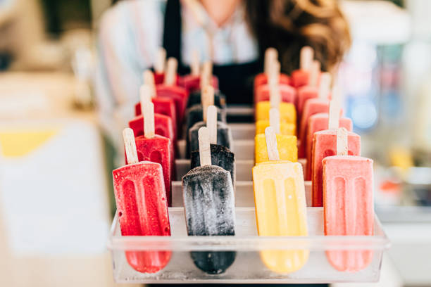 istock Happy brunette worker in ice cream store 1406919464