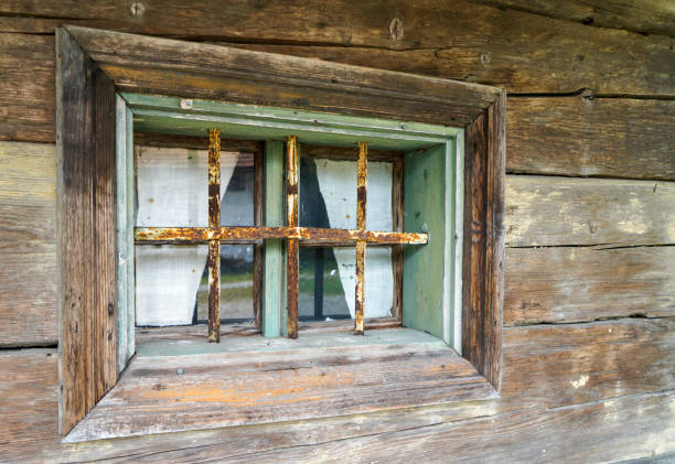 Aged wooden window with glazing and partially weathered in rustic homes