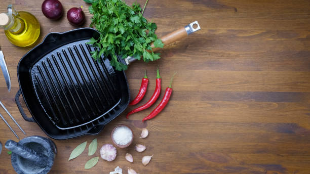 istock Black iron empty grill pan on wooden texture 1406922392