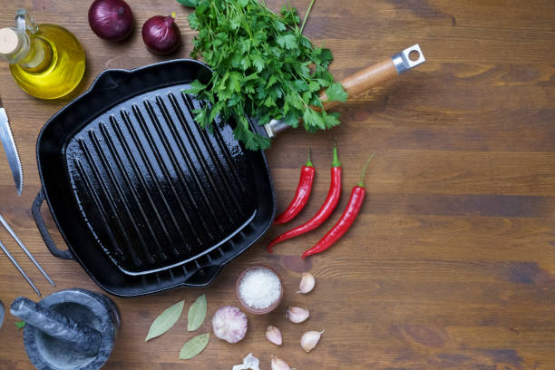 istock Black iron empty grill pan on wooden texture 1406922603