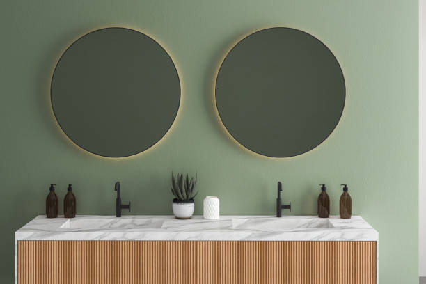 istock Comfortable white marble basin with oval mirrors are standing on wooden countertop 1406922780