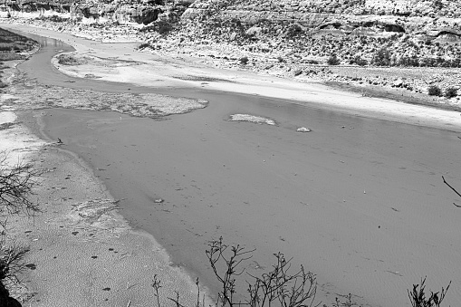 Black and White photo of length of winding Pecos river during dry spring in Southwest Texas.