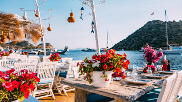 istock Dining Table Decorated With Flowers by the Sea 1406926144