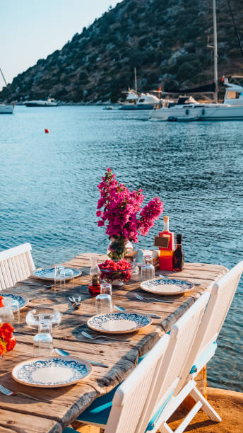 istock Dining Table Decorated With Flowers by the Sea 1406926473