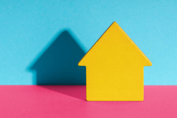istock Wooden toy brick house symbol with shadow 1406926542