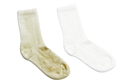 Comparison of white socks before and after using laundry detergent or bleach on white background
