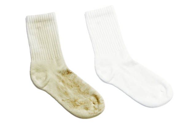 Comparison of white socks before and after using laundry detergent or bleach Comparison of white socks before and after using laundry detergent or bleach on white background dirty socks stock pictures, royalty-free photos & images