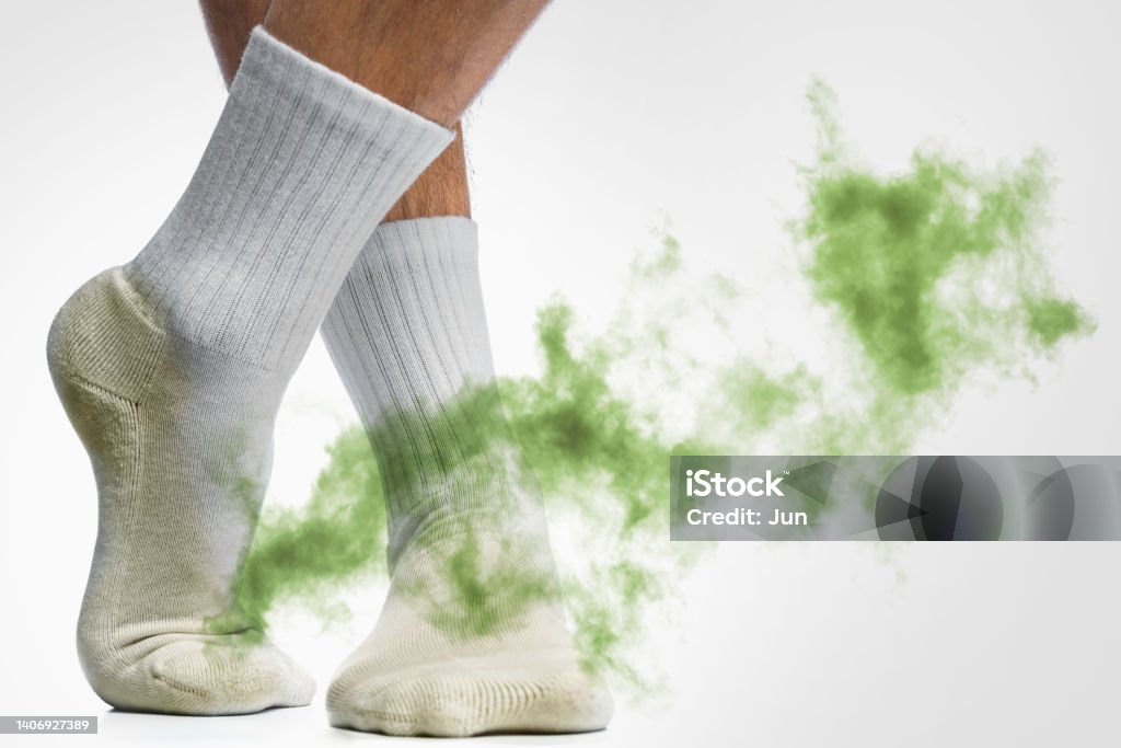 Male feet with smelly dirty socks Male feet with smelly dirty socks on white background Unpleasant Smell Stock Photo