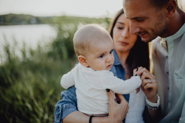 istock Baby boy with parents outside 1406927422