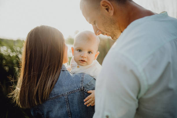istock Baby boy with his parents in nature 1406927424