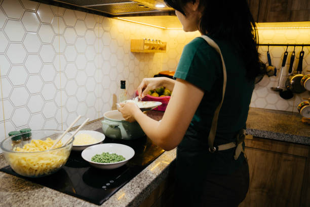 istock Asian Woman preparing food 1406928144