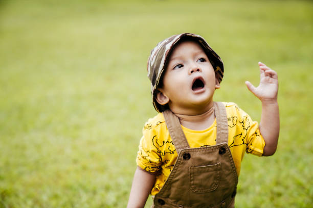 istock Baby boy playing and  running on lawn in spring 1406928270