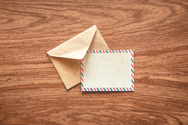 istock Envelope with a postcard for an inscription on a wooden background, flat lay. 1406928969