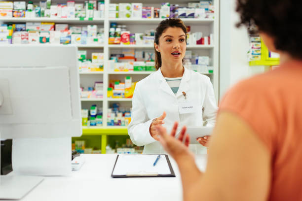 istock Pharmacist serving a customer patient in a pharmacy 1406929117