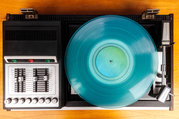 istock Vintage turntable vinyl record player with turquoise vinyl 1406929764