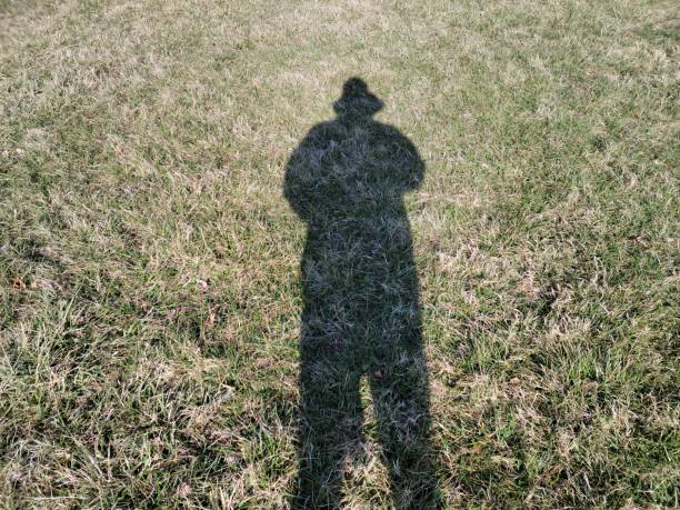 black shadow of person in grass or lawn or yard