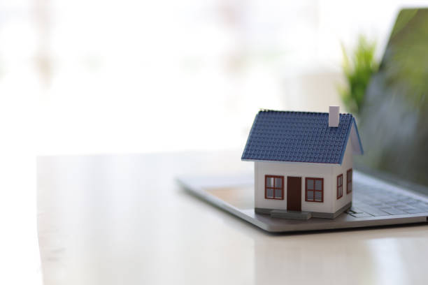 istock Real estate concept. Home model on laptop keyboard and copy space. 1406932196