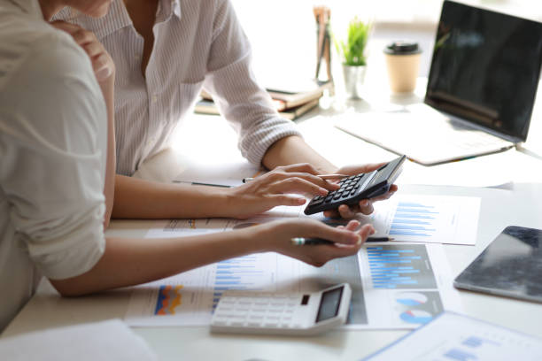 istock Finance and Accounting Concepts. Financial advisors and colleagues discuss and are analyzing market strategies and business investment planning. 1406932202