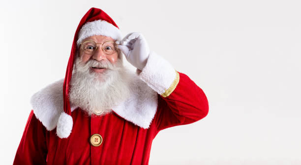 istock Santa Claus in eyeglasses is looking at camera and smiling, on white background 1406932419