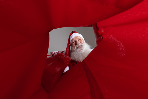 Image from inside the sack, Santa Claus putting gifts into the sack.