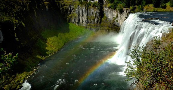 Upper Mesa Falls waterfall water fall rugged canyon with mist and rainbows