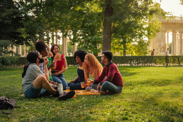 istock Cheerful friends having picnic outdoors 1406934597