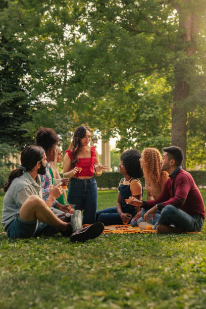 istock Friends sitting on park lawn 1406934610