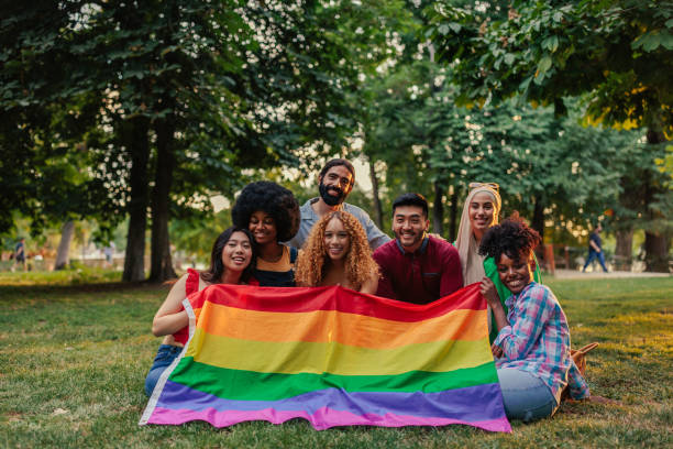 istock Gay rights activists with pride flag outside 1406934622