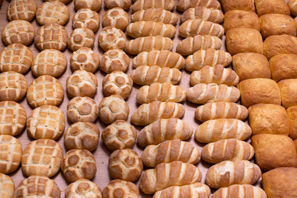 istock Various Types of Bread Buns displayed Orderly on Top of a Wooden Display Stand from an Italian Bakery 1406934883