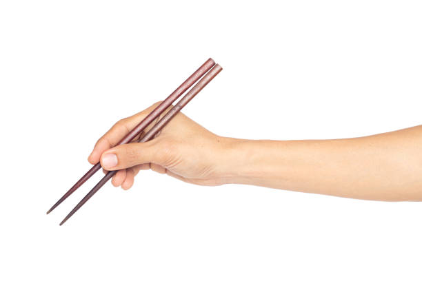 istock Hand man holding chopsticks isolated on a white background 1406934897