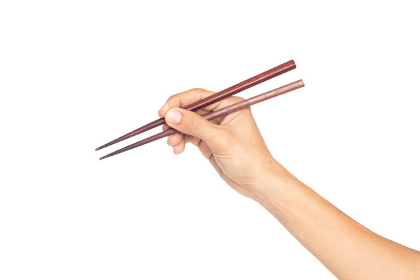 Hand man holding chopsticks isolated on a white background stock photo