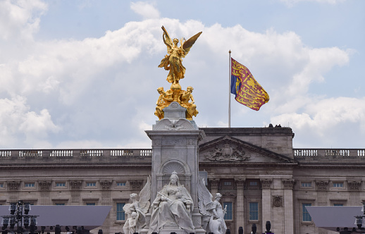 London, UK. 2nd June 2022: Victoria Memorial and the Royal Standard flag on Buckingham Palace, indicating that The Queen is in residence.