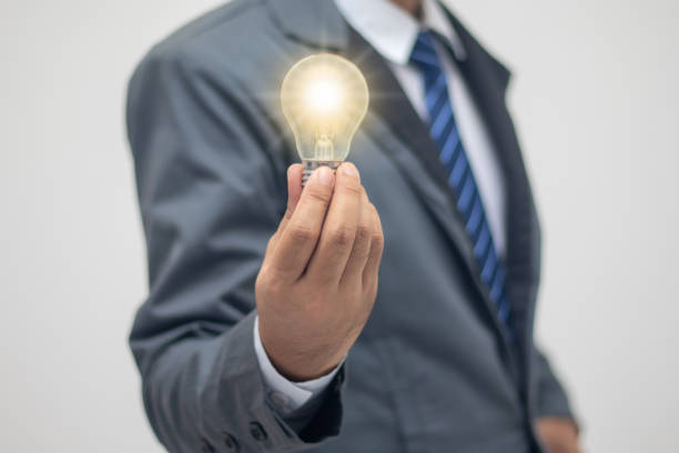 istock businessman holding a bright light bulb 1406937662