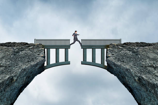 istock Man Steps Across Missing Piece Of A Bridge 1406941240