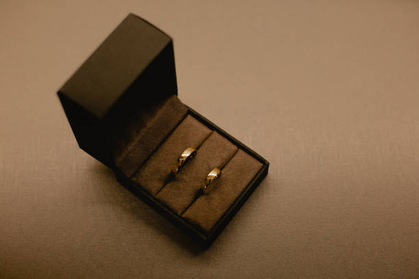 istock Black ring holder with two gold rings 1406941864
