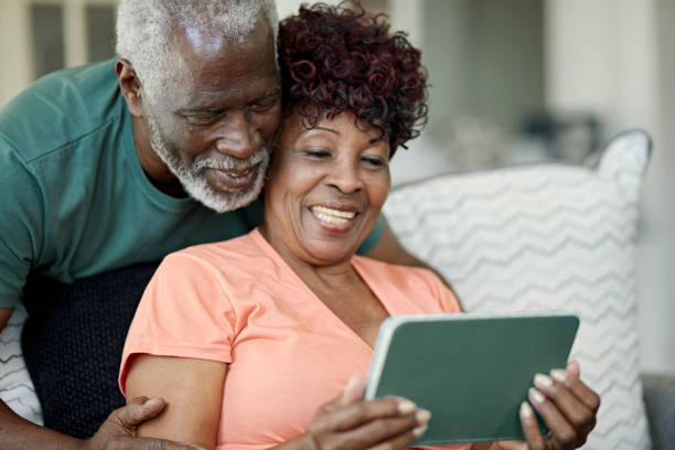 istock Black couple enjoying leisure time with digital tablet 1406942054