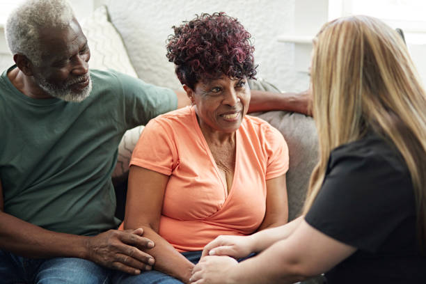 istock Senior Black couple talking with home caregiver 1406942055
