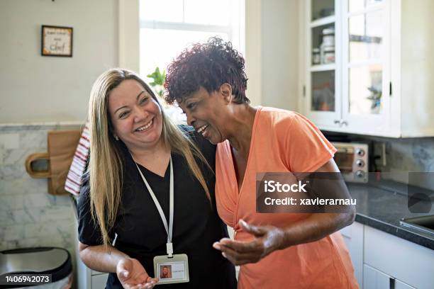 Miami Senior Woman And Home Caregiver Together In Kitchen Stock Photo - Download Image Now
