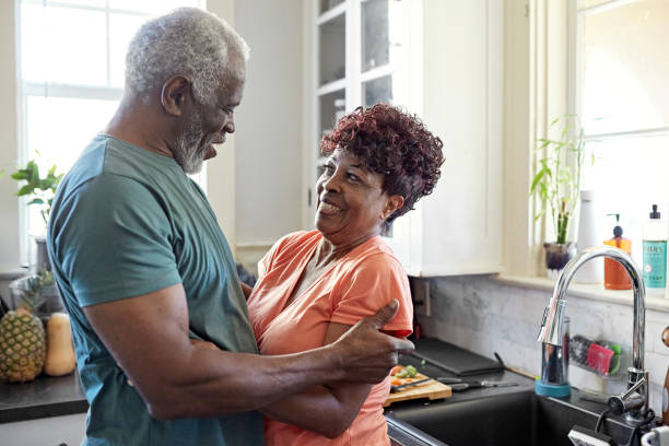 istock Smiling Black seniors embracing in family kitchen 1406942091