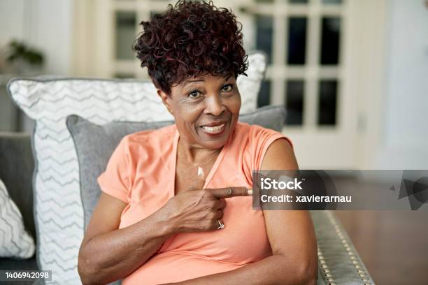 Black Woman In Late 70s Pointing To Vaccination Stock Photo - Download Image Now - Senior Adult, Adhesive Bandage, Booster Dose
