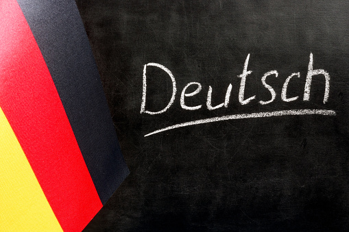 Flag of Germany and chalkboard with the inscription Deutsch.