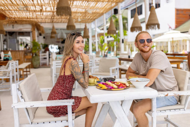 istock Caucasian couple having a breakfast at the beach restaurant 1406943895