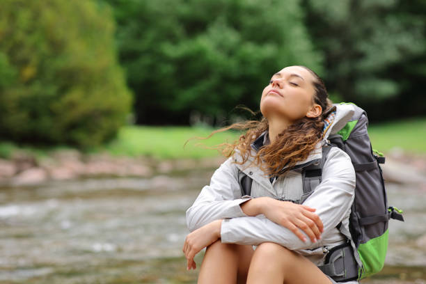 istock Trekker resting and breathing in a riverside 1406948327
