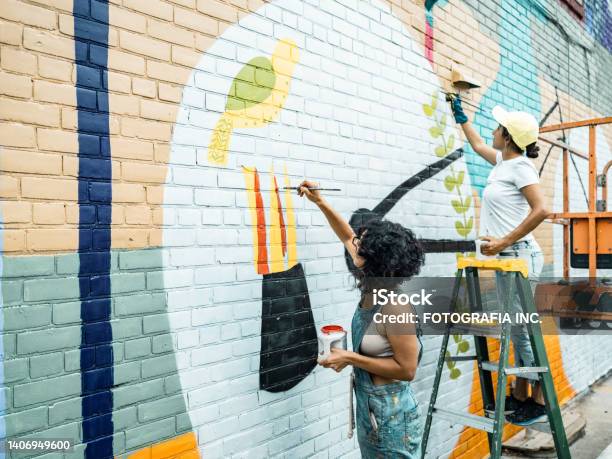 Two Female Artists Painting Large Wall Mural Stock Photo - Download Image Now - Art, Painting - Activity, Wall - Building Feature