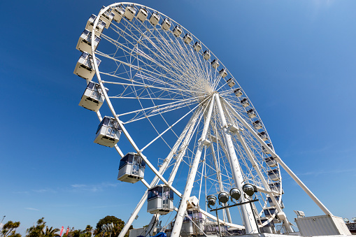 Eastbourne, England - Apr 30, 2022: Eastbourne observation Ferris wheel on the south coast of Sussex. It is close to the famous Eastbourne Pier and is a popular tourist destination. A ride on the wheel gives the passenger a view high over Eastbourne beach and town.