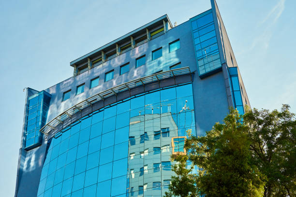 istock Modern office building with green trees 1406950479