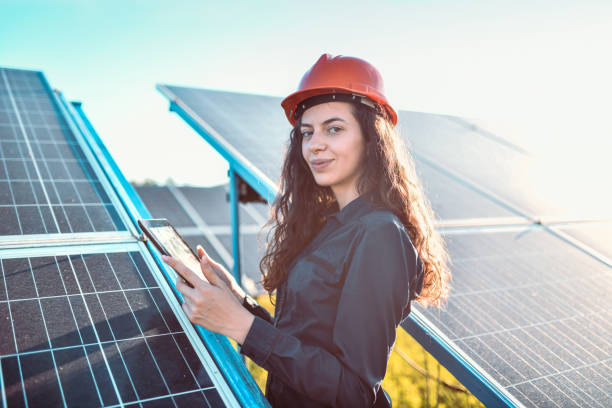 istock Happy Female Is Calibrating Solar Panels With Digital Tablet 1406950942