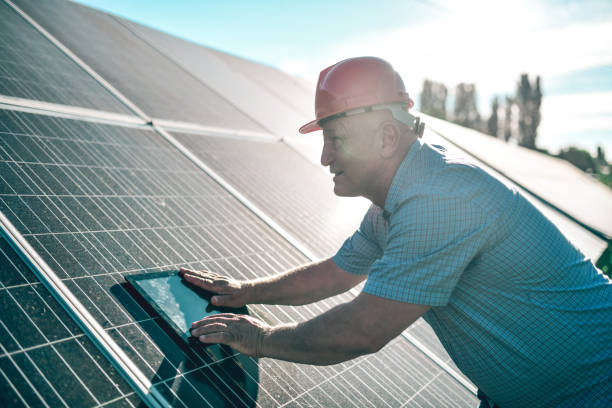 istock Senior Male Engineer Comparing Solar Panel Production Rates On Digital Tablet App 1406951126